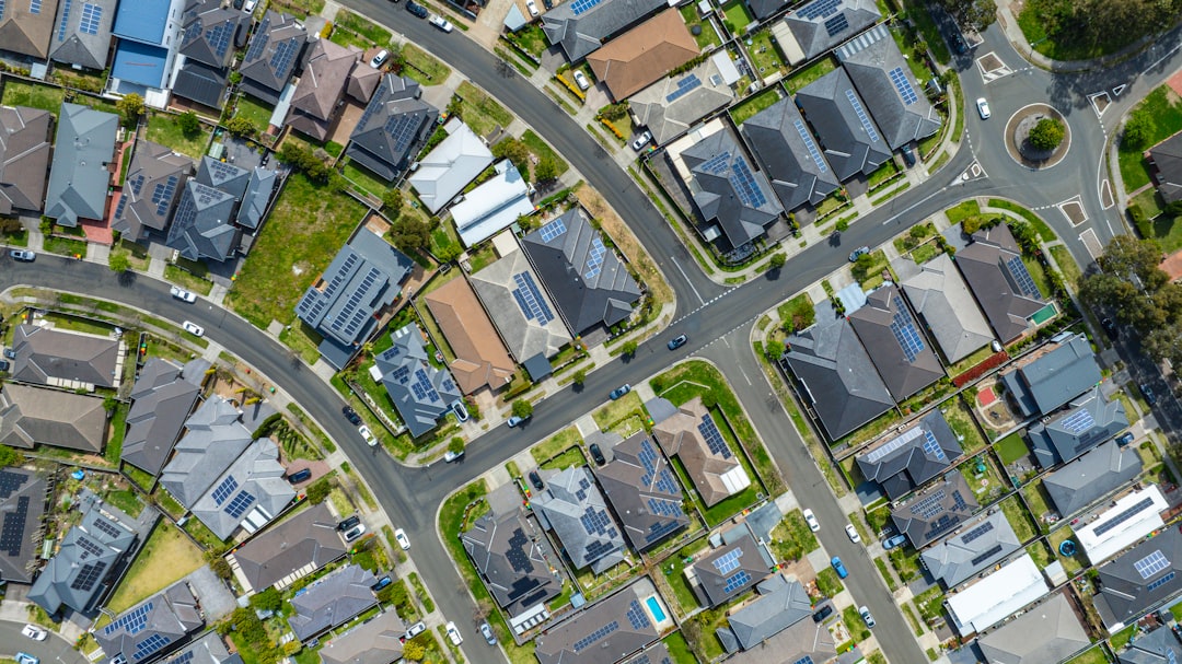 Aerial top-down view of a modern Sydney, NSW suburb featuring solar-powered rooftops and structured street planning, reflecting Australia’s growing housing density and shift toward renewable residential energy.